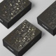 Black folding carton with golden embossing